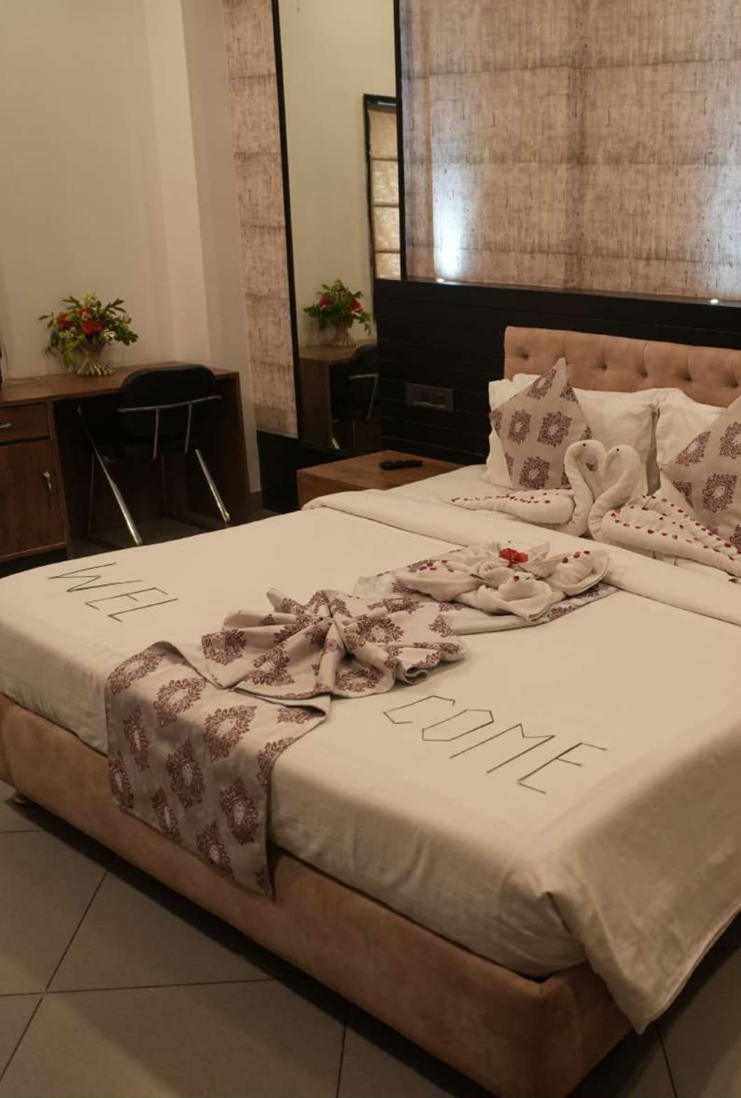 Nakshatra Hotel Luxury Master Bedroom with Swans Art on Bed